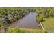 Scenic aerial view of the lake and a paved path with surrounding lush trees and beautiful homes at 109 Jones Creek Pl, Chapel Hill, NC 27516