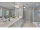 Bright bathroom with dual sinks, a walk-in shower, and separate bathtub at 109 Jones Creek Pl, Chapel Hill, NC 27516