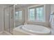 Bright bathroom featuring a glass shower, soaking tub, and large window at 109 Jones Creek Pl, Chapel Hill, NC 27516