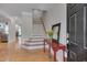 Light-filled foyer with hardwood floors, staircase, and stylish console table at 109 Jones Creek Pl, Chapel Hill, NC 27516