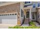 Inviting front entrance of a townhome with brick accents and a well-manicured landscape at 109 Jones Creek Pl, Chapel Hill, NC 27516