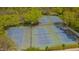 Aerial view of well-maintained tennis and basketball courts, surrounded by trees, for active recreation at 109 Jones Creek Pl, Chapel Hill, NC 27516
