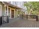 Spacious back porch with wood railing offers outdoor enjoyment in a serene setting at 1105 W Lenoir St, Raleigh, NC 27603