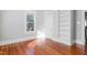 Well-lit bedroom with hardwood floors and built-in shelving, offering style and functionality at 1105 W Lenoir St, Raleigh, NC 27603