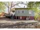 Charming home exterior featuring a wooden deck, brick foundation, and gravel yard at 1105 W Lenoir St, Raleigh, NC 27603