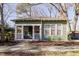 Charming green home with white trim, front porch and landscaped yard at 1105 W Lenoir St, Raleigh, NC 27603