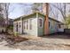 Charming home exterior with a brick chimney, covered porch, and gravel landscaping at 1105 W Lenoir St, Raleigh, NC 27603