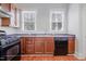 Functional kitchen with wood cabinets, tiled countertops, and updated appliances at 1105 W Lenoir St, Raleigh, NC 27603