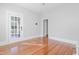 Bright living room with access to a covered porch, hardwood floors, and neutral decor at 1105 W Lenoir St, Raleigh, NC 27603