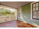 Inviting covered front porch with wood floors and lots of natural light at 1105 W Lenoir St, Raleigh, NC 27603