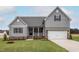 Charming two-story home with a landscaped yard, covered porch, and two car garage at 11430 International Dr, Middlesex, NC 27557