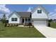 Charming white two-story home with well-manicured lawn and inviting curb appeal at 11430 International Dr, Middlesex, NC 27557