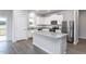 Modern kitchen with stainless steel appliances, granite counters, and a center island at 11430 International Dr, Middlesex, NC 27557