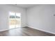Bright and airy bedroom with LVP flooring, a sliding glass door, and backyard views at 11450 International Dr, Middlesex, NC 27557
