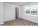 An empty bedroom with carpet flooring and a window for natural light at 11682 International Dr, Middlesex, NC 27557