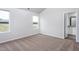 An empty bedroom includes carpet flooring, two windows, and a view to the outside at 11682 International Dr, Middlesex, NC 27557