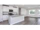 Well-equipped kitchen featuring white cabinetry, a stainless steel refrigerator, and an island with granite countertops at 11682 International Dr, Middlesex, NC 27557