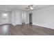 Spacious living room with modern gray wood-look flooring, neutral walls, and multiple doorways at 11682 International Dr, Middlesex, NC 27557