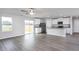 Open-concept living area with access to a deck, connecting seamlessly to the kitchen with stainless appliances at 11682 International Dr, Middlesex, NC 27557