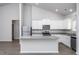 Kitchen with white cabinets, stainless steel appliances, granite countertops, and island at 11740 International Dr, Middlesex, NC 27557