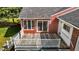 Aerial view of deck, sliding glass doors, and brick wall featuring a welcome mat at 118 Shannon Dr, Burlington, NC 27215
