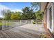 Spacious wooden back deck overlooking the yard, featuring white railings and access to the yard at 118 Shannon Dr, Burlington, NC 27215