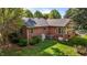 Back aerial view featuring a red brick home with a green lawn and HVAC system at 118 Shannon Dr, Burlington, NC 27215