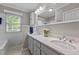 Well-lit bathroom featuring double sinks, vanity, and a large mirror at 118 Shannon Dr, Burlington, NC 27215