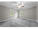 Cozy bedroom with carpet flooring, two windows providing lots of natural light, and ceiling fan at 118 Shannon Dr, Burlington, NC 27215