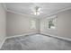 Cozy bedroom featuring natural light from two windows and plush carpet flooring at 118 Shannon Dr, Burlington, NC 27215
