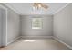 Neutral bedroom featuring soft carpet, fresh paint, ceiling fan, and bright window at 118 Shannon Dr, Burlington, NC 27215