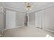 Freshly painted, neutral bedroom featuring soft carpet, ceiling fan, closet, and access to other rooms at 118 Shannon Dr, Burlington, NC 27215