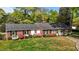 Charming brick home featuring lush landscaping and a well-manicured lawn at 118 Shannon Dr, Burlington, NC 27215