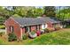 Charming single-story brick home featuring a well-maintained lawn and colorful azaleas at 118 Shannon Dr, Burlington, NC 27215