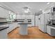 Bright kitchen featuring white cabinetry, black countertops, and modern appliances at 118 Shannon Dr, Burlington, NC 27215