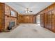 The living room features a brick fireplace, wood-paneled walls, and french doors to the sunroom at 118 Shannon Dr, Burlington, NC 27215