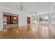 Open-concept living room with wood floors, large windows, and access to an adjacent room at 118 Shannon Dr, Burlington, NC 27215