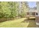 Expansive backyard with a well-maintained lawn and a wooden deck, perfect for outdoor activities at 1201 Bellenden Dr, Durham, NC 27713