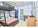 Bright bedroom featuring a bunk bed, blue bookshelf, and a window providing natural light at 1201 Bellenden Dr, Durham, NC 27713