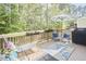 Relaxing deck with outdoor seating, an umbrella for shade, and a view of the wooded backyard at 1201 Bellenden Dr, Durham, NC 27713