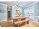 Well-lit dining area with hardwood floors and a modern chandelier at 1201 Bellenden Dr, Durham, NC 27713