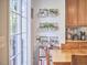 Bright dining area with sliding glass doors, featuring a wooden table and chairs, cabinets and plant decor at 1201 Bellenden Dr, Durham, NC 27713