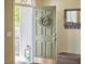 Inviting entryway with a charming sage green front door and a stylish mirror at 1201 Bellenden Dr, Durham, NC 27713