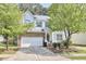 Charming two-story home with stone accents, well-manicured lawn, and mature trees at 1201 Bellenden Dr, Durham, NC 27713