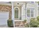 Welcoming front entrance with a decorative wreath and neatly landscaped bushes at 1201 Bellenden Dr, Durham, NC 27713