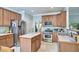 Traditional kitchen featuring stainless steel appliances, wooden cabinets, and a center island with a light countertop at 1201 Bellenden Dr, Durham, NC 27713