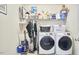 Laundry room with white washer and dryer, sink, and ample storage space at 1201 Bellenden Dr, Durham, NC 27713