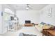 Bright living room with large window, desk, futon and ceiling fan at 1201 Bellenden Dr, Durham, NC 27713