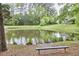 Scenic pond view, grassy shoreline, with a bench providing a peaceful spot to relax at 1201 Bellenden Dr, Durham, NC 27713