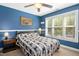 Cozy bedroom features a ceiling fan, two side tables and a brightly painted blue wall at 1503 Anterra Dr, Wake Forest, NC 27587